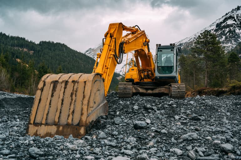 Excavator machine rental digging dirt on construction site